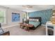 Bedroom with wallpapered accent wall, desk, and platform TV stand at 9940 Koupela Dr, Raleigh, NC 27614