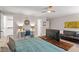 Bedroom with desk, ceiling fan, and platform TV stand with couch at 9940 Koupela Dr, Raleigh, NC 27614