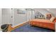 Bedroom features an orange bedspread, blue rug, and sliding barn door at 9940 Koupela Dr, Raleigh, NC 27614