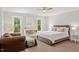 This bedroom features natural light, neutral paint, plush carpet, and ample closet space at 9940 Koupela Dr, Raleigh, NC 27614