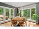 Breakfast nook featuring a round table, gold chairs, hardwood floors, and backyard views at 9940 Koupela Dr, Raleigh, NC 27614