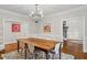 Dining room with a wooden table, modern lighting, and art at 9940 Koupela Dr, Raleigh, NC 27614