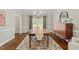 Dining room with a large wood table, modern chairs, and stylish lighting at 9940 Koupela Dr, Raleigh, NC 27614