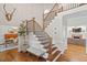 Inviting foyer with hardwood floors, a staircase, and elegant decor at 9940 Koupela Dr, Raleigh, NC 27614