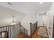 This hallway features hardwood floors, modern lighting, a staircase and neutral paint at 9940 Koupela Dr, Raleigh, NC 27614