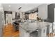 Spacious kitchen features an island with seating, granite countertops, stainless steel appliances, and hardwood floors at 9940 Koupela Dr, Raleigh, NC 27614