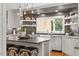 Kitchen features sleek countertops, stainless steel appliances, white cabinetry, and open shelving at 9940 Koupela Dr, Raleigh, NC 27614