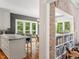 View of kitchen with island seating and dining room with lots of light at 9940 Koupela Dr, Raleigh, NC 27614
