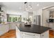 Open kitchen featuring stainless steel appliances, white cabinets, and breakfast nook with backyard view at 9940 Koupela Dr, Raleigh, NC 27614