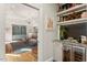 Cozy living room boasts shelving, hardwood floors, an elegant chandelier, and a comfortable gray sofa at 9940 Koupela Dr, Raleigh, NC 27614
