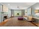 Spacious living room with a brick fireplace, large area rug, modern furniture, and plenty of natural light at 9940 Koupela Dr, Raleigh, NC 27614