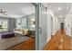 Open-concept living room featuring hardwood floors, soft blue walls, and a decorative barn door entrance at 9940 Koupela Dr, Raleigh, NC 27614