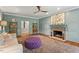 Comfortable living room with stylish shelving, brick fireplace, plush seating, and soft, blue-green walls at 9940 Koupela Dr, Raleigh, NC 27614