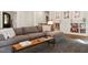 Living room features a plush gray sofa, hardwood floors, and custom built-in bookshelves at 9940 Koupela Dr, Raleigh, NC 27614