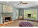Inviting living room with brick fireplace, large windows, shutters, and stylish decor at 9940 Koupela Dr, Raleigh, NC 27614