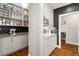 Pantry with open shelving, white cabinets, stone counter, and easy access to adjacent rooms at 9940 Koupela Dr, Raleigh, NC 27614