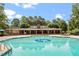 Community pool with ample lounge chairs and covered seating area at 9940 Koupela Dr, Raleigh, NC 27614