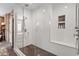 This bathroom features a glass enclosed shower with white tiled walls and a built-in shower seat at 9940 Koupela Dr, Raleigh, NC 27614