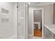 Modern tiled shower with glass doors and built-in shelving in bathroom at 9940 Koupela Dr, Raleigh, NC 27614