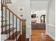 Close up of the staircase, showcasing hardwood floors and living room view at 9940 Koupela Dr, Raleigh, NC 27614