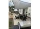 Backyard patio area with shade covering, outdoor furniture, and a fire pit at 10 Oxford Dr, Angier, NC 27501