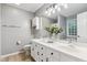 Bright bathroom with double vanity, white cabinets, and large mirror at 10 Oxford Dr, Angier, NC 27501