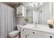 Bathroom featuring white vanity, updated fixtures, and tiled floors at 10 Oxford Dr, Angier, NC 27501