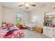 Bright bedroom featuring a toddler bed, crib, and built-in bookcase at 10 Oxford Dr, Angier, NC 27501
