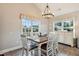 Cozy dining area with natural light, modern chandelier, and wood table with seating at 10 Oxford Dr, Angier, NC 27501