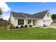 Charming one-story home featuring a welcoming porch swing and well-manicured lawn at 10 Oxford Dr, Angier, NC 27501