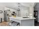 Modern kitchen with white cabinets, stainless steel appliances, and a breakfast bar with seating at 10 Oxford Dr, Angier, NC 27501