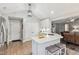 Open kitchen design with white cabinets, a breakfast bar, and views into the living area at 10 Oxford Dr, Angier, NC 27501