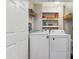Bright laundry room with white washer and dryer, shelving and storage solutions at 10 Oxford Dr, Angier, NC 27501