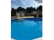Above ground pool with ladder access, surrounded by a wooden deck at 10 Oxford Dr, Angier, NC 27501