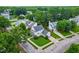 Aerial view of a lovely home with a well-kept lawn, surrounded by lush green trees in a tranquil neighborhood at 100 Fountain Springs Rd, Holly Springs, NC 27540
