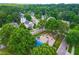 Overhead view of a community playground, set amongst verdant trees and residential properties at 100 Fountain Springs Rd, Holly Springs, NC 27540