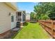 Spacious backyard with a screened porch, grill, trampoline, and well-maintained lawn, ideal for outdoor activities at 100 Fountain Springs Rd, Holly Springs, NC 27540