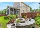 Backyard patio featuring a fire pit, Adirondack chairs, and lush landscaping, perfect for outdoor entertaining at 100 Fountain Springs Rd, Holly Springs, NC 27540
