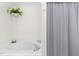 Bathroom featuring a soaking tub and a shower with a striped curtain at 100 Fountain Springs Rd, Holly Springs, NC 27540