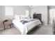 Bright bedroom with two windows, bed with white comforter, and neutral decor at 100 Fountain Springs Rd, Holly Springs, NC 27540