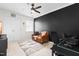 Nicely decorated bedroom featuring a stylish tan sofa, a patterned rug, and a sleek black accent wall at 100 Fountain Springs Rd, Holly Springs, NC 27540