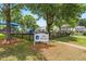 Arbor Creek Village: Playground with a sign, featuring play equipment and grassy areas for Gathering fun at 100 Fountain Springs Rd, Holly Springs, NC 27540