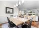 Dining room with stylish light fixture, wood floors, and comfortable seating at 100 Fountain Springs Rd, Holly Springs, NC 27540