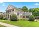 Charming two-story home with manicured lawn, trimmed bushes, and black shutters, showcasing curb appeal at 100 Fountain Springs Rd, Holly Springs, NC 27540