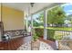 Relaxing front porch with a swing, wicker chairs, and scenic neighborhood views at 100 Fountain Springs Rd, Holly Springs, NC 27540