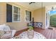 Cozy front porch featuring a porch swing, comfortable seating, and natural light at 100 Fountain Springs Rd, Holly Springs, NC 27540