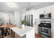 Kitchen with stainless steel appliances and a center island with light countertops at 100 Fountain Springs Rd, Holly Springs, NC 27540