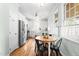 Eat-in kitchen featuring stainless steel appliances, and white cabinetry with a view of the backyard at 100 Fountain Springs Rd, Holly Springs, NC 27540