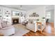 Cozy living room with a fireplace, built-in shelves, and comfortable seating, perfect for relaxation and entertaining at 100 Fountain Springs Rd, Holly Springs, NC 27540