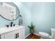 Stylish powder room with vessel sink, modern fixtures, and refreshing light blue walls at 100 Fountain Springs Rd, Holly Springs, NC 27540